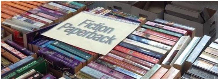 Picture of books for sale with a sign saying "fiction"