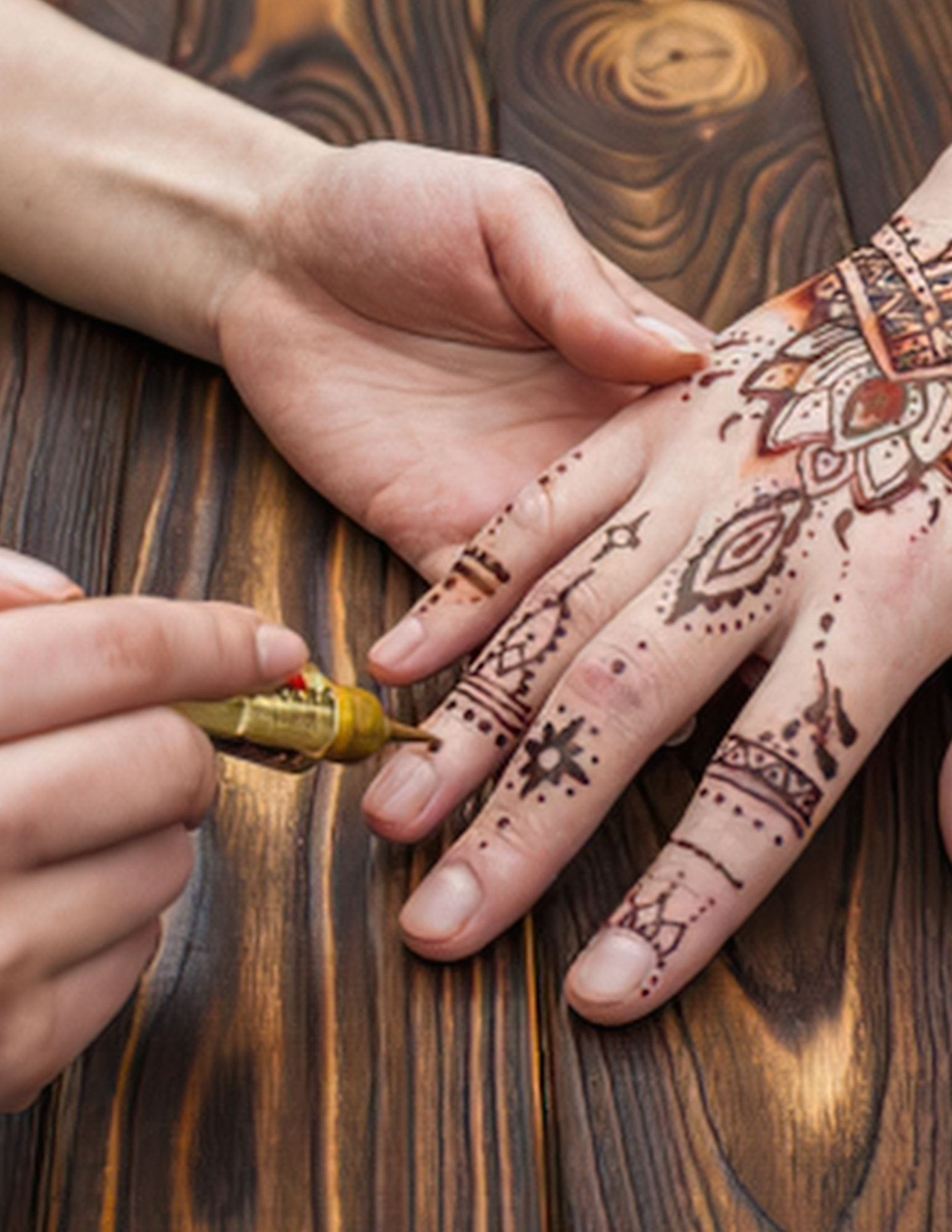 Picture of henna tattoo being applied to a hand
