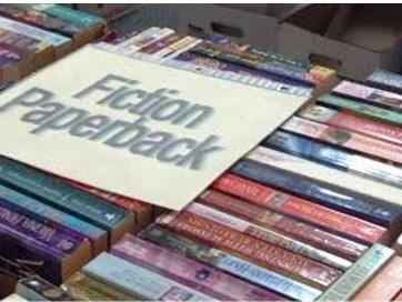 Picture of books for sale with a sign saying "fiction"