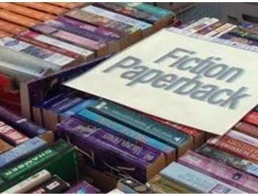 Picture of books for sale with a sign saying "fiction"