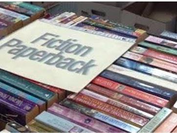 Picture of books for sale with a sign saying "fiction"