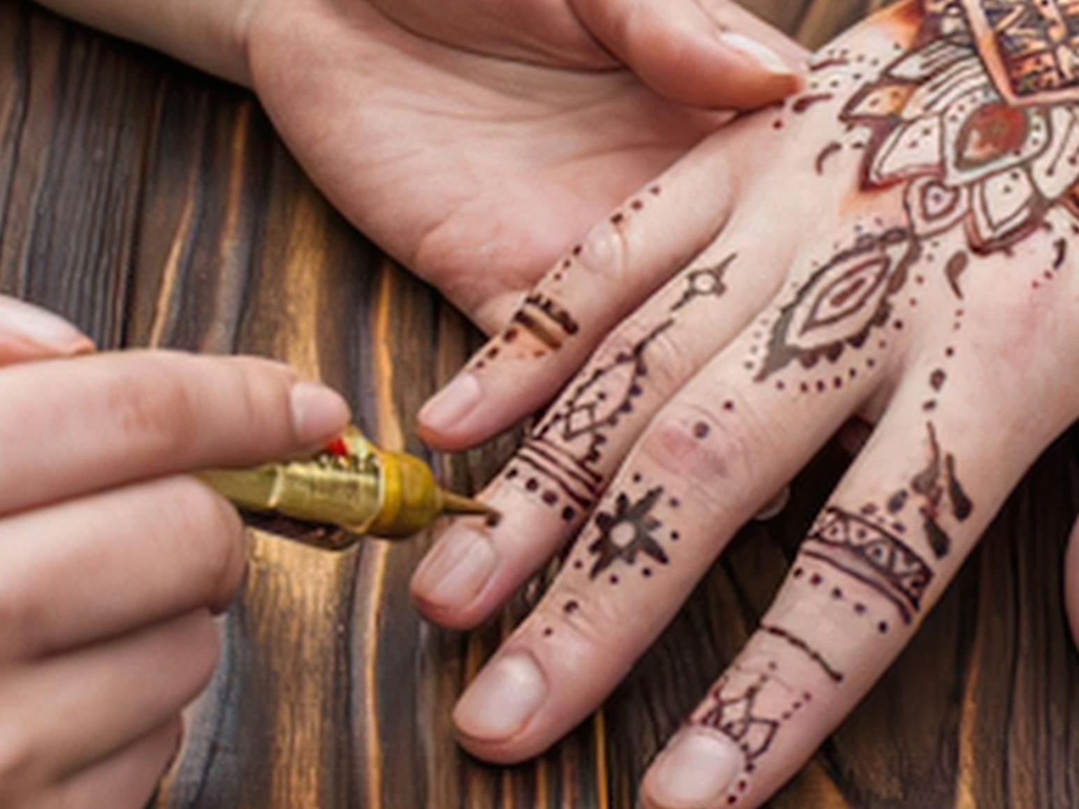 Henna Tattoo being applied to a hand