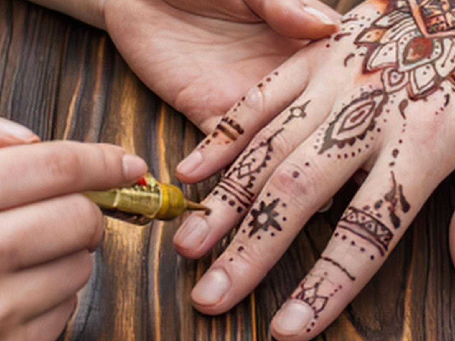 Picture of henna tattoo being applied to a hand